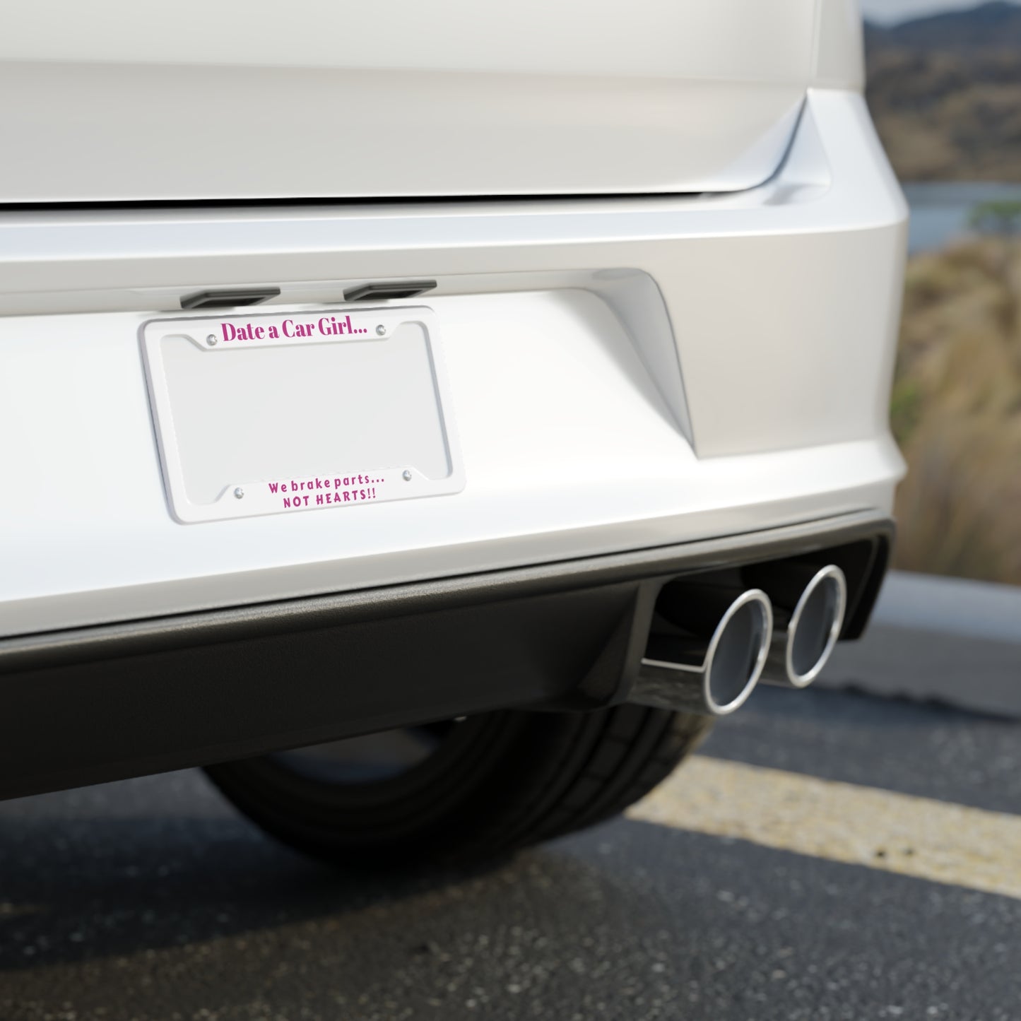 White license plate frame with pink text on a white background