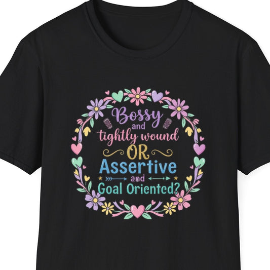 Black t-shirt with colorful text and floral design on a white background