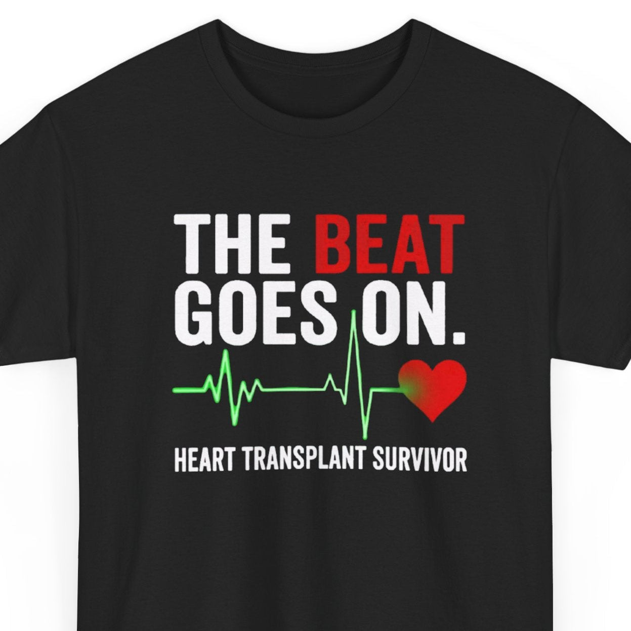 Black t-shirt with 'The Beat Goes On. Heart Transplant Survivor' text and heart design on a white background
