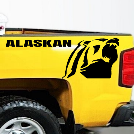 Yellow pickup truck with a Chevrolet Alaskan Black vinyl decal, die-cut