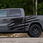 Distressed black American flag vinyl decal displayed across the side of a grey pickup truck