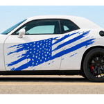 Distressed blue American flag vinyl decal displayed across the side of a white muscle car