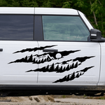 Black claw mark mountain and pine tree vinyl decal displayed on a white Ford Bronco-style truck