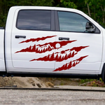 Red claw mark mountain and pine tree vinyl decal displayed on a white truck