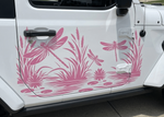 Pink dragonfly and reeds vinyl decal applied to the side door of a white vehicle.