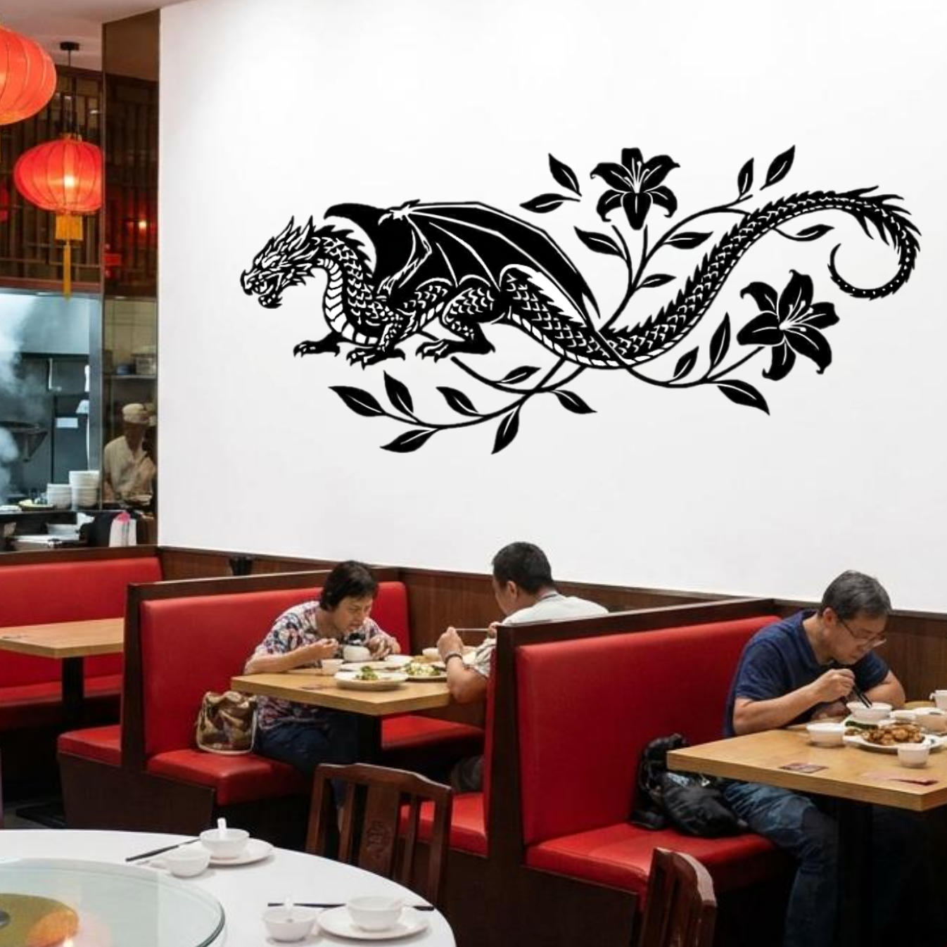 Dining area with red booths and a large wall decal of a dragon design.