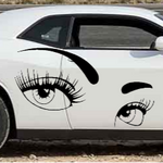 Car with eye and eyelash decals on a white background