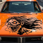 “Female zombie vinyl car/wall decal, black, die‑cut with no background on orange car hood”