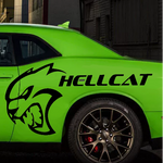 A bright lime green Dodge Challenger SRT Hellcat shown in profile, parked in an urban alley. The car features a black hood stripe, black wheels, and a large black graphic of a roaring cat head with the word 'HELLCAT' printed on the rear side door.