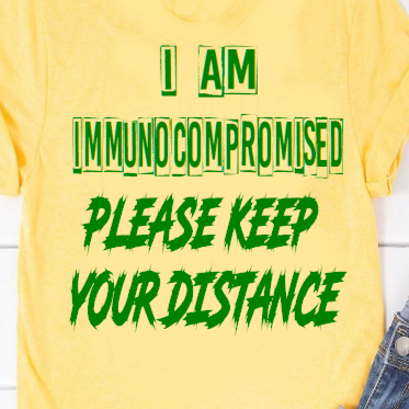 “I am immunocompromised — please keep your distance graphic t‑shirt, yerllow, unisex, front view”