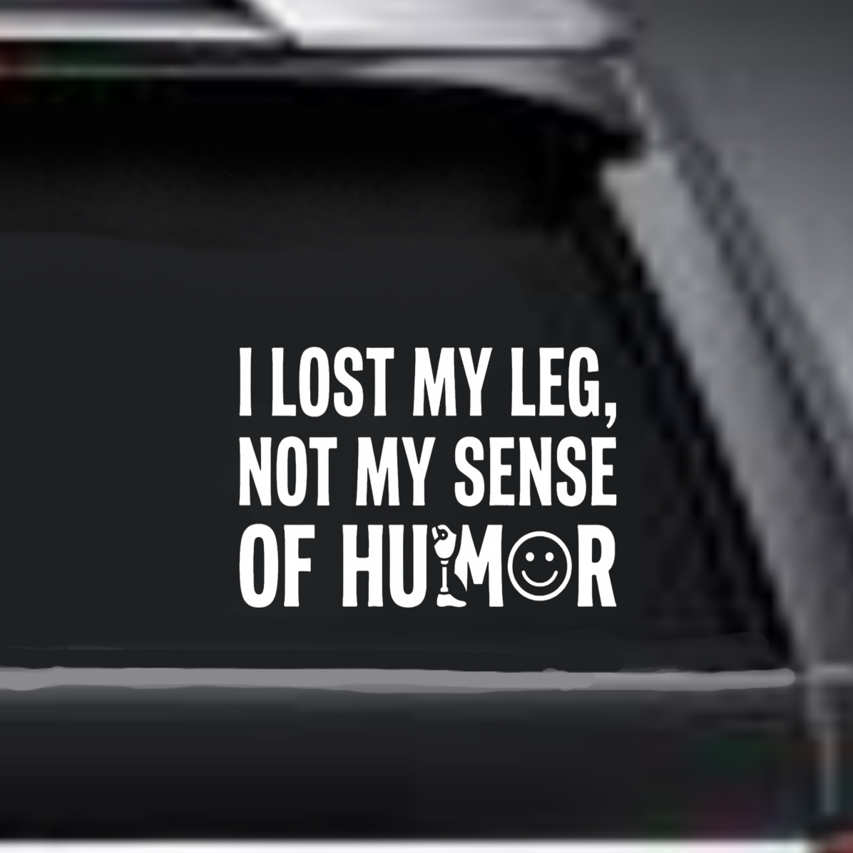 Sticker on a car window with text 'I lost my leg, not my sense of humor'.