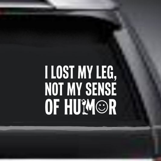 Sticker on a car window with text 'I lost my leg, not my sense of humor'.