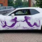 A white car with a purple vinyl decal of a mermaid and  a merman touching hands