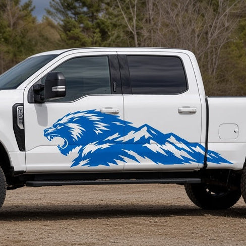 Blue Mountain Beast decal, a roaring beast head blending into a mountain range, on the side of a white pickup truck