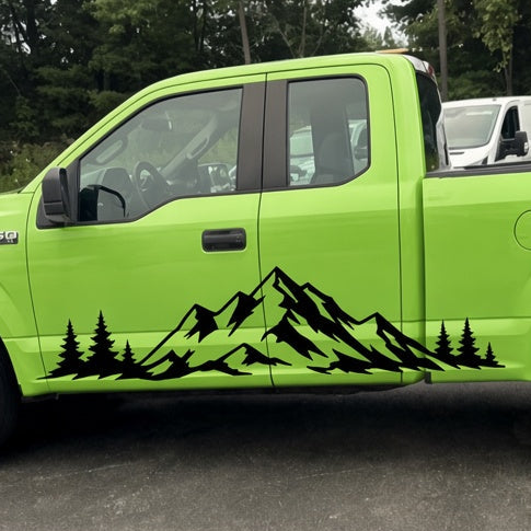 Black mountain range and pine tree side decal on a lime green pickup truck