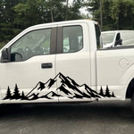 Black mountain range and pine tree vinyl decal on the lower side of a white Ford F-150 pickup truck