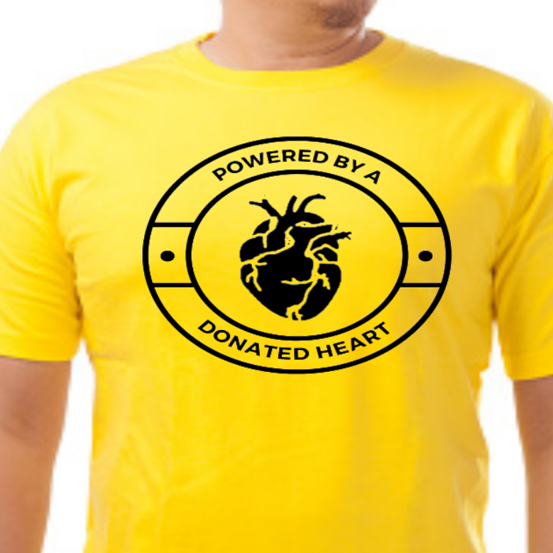 “Powered by a Donated Heart unisex graphic t‑shirt, black with white HTV text, front view”