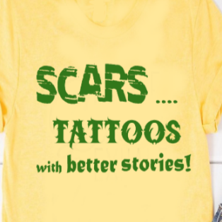 “Scars: Tattoos with Better Stories" tee, red shirt with black vinyl text, flat lay