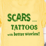 “Scars: Tattoos with Better Stories" tee, red shirt with black vinyl text, flat lay