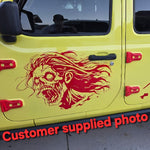 “Female zombie vinyl car/wall decal, white, die‑cut with no background on orange car hood”