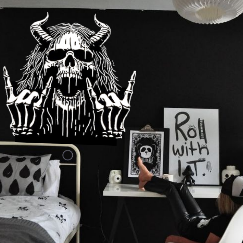 Modern bedroom with black and white decor, including a bed with a skull design headboard.