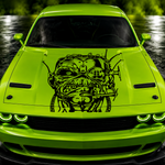 Lime green car with Eddie from Iron Maiden black graphic on the hood, set against a dark background.