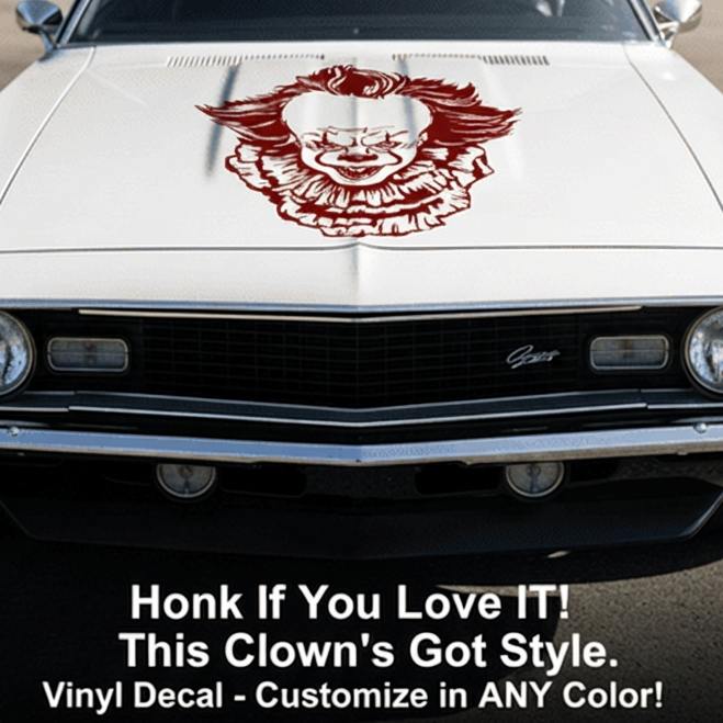 White car with Pennywise inspired clown vinyl decal on the hood, parked in an outdoor setting.