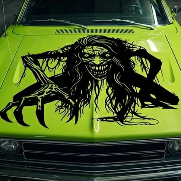 “Zombie/Banshee ‘Black Annis’ vinyl hood decal, white, die‑cut with no background on green car”