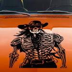 Orange car with a cowboy skeleton vinyl decal and text in a desert setting