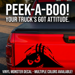 Red truck with vinyl monster decal and text 'PEEK-A-BOO! YOUR TRUCK'S GOT ATTITUDE.'