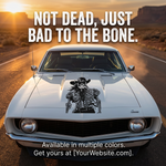 Vintage car with a cowboy skeleton decal on a desert road with text 'Not dead, just bad to the bone'.