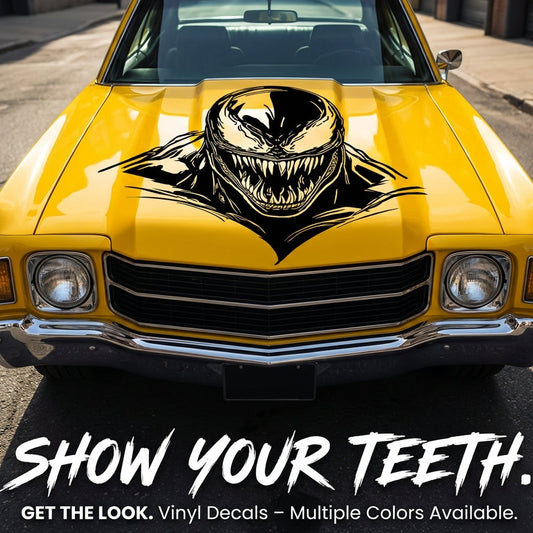 Yellow car with a vinyl decal of an Venom on the hood, parked on a street.