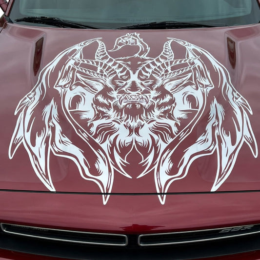 Muscle car with a large silver chimera creature decal featuring lion, goat, and serpent elements displayed across the hood

