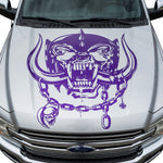 Silver  car with aggressive war pig skull hood decal featuring tusks and chain design