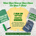 “Organ recipient ‘I Run On Gifted Parts’ tee, yellow shirt with green vinyl text, flat lay”