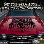 "Black vinyl decal of hooded Grim Reaper skull with large feathered angel wings, centered on blue muscle car hood."

