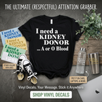 “I Need a Kidney Donor unisex graphic t‑shirt, black with white HTV text, front view”