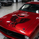 Large black griffin vinyl decal with spread wings applied to the hood of a red car, featuring a detailed eagle and lion hybrid design