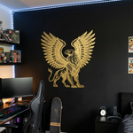 Large gold griffin vinyl decal with spread wings applied to the wall, featuring a detailed eagle and lion hybrid design