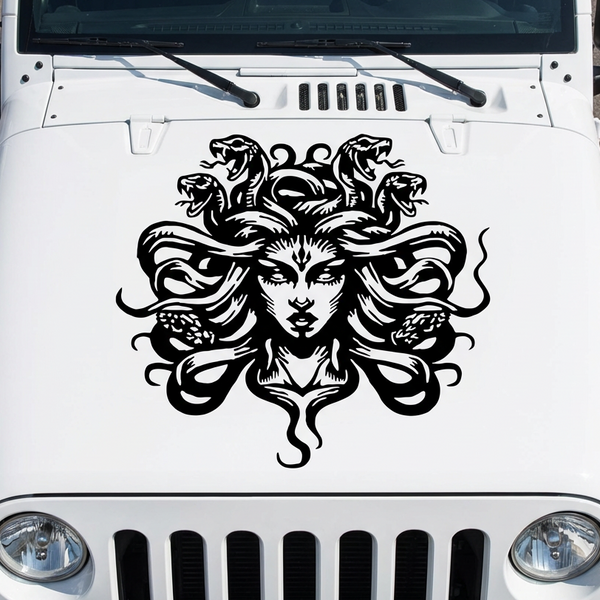 White Jeep with a Medusa head vinyl decal on the hood