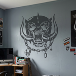 Bedroom wall with aggressive war pig skull decal featuring tusks and chain design