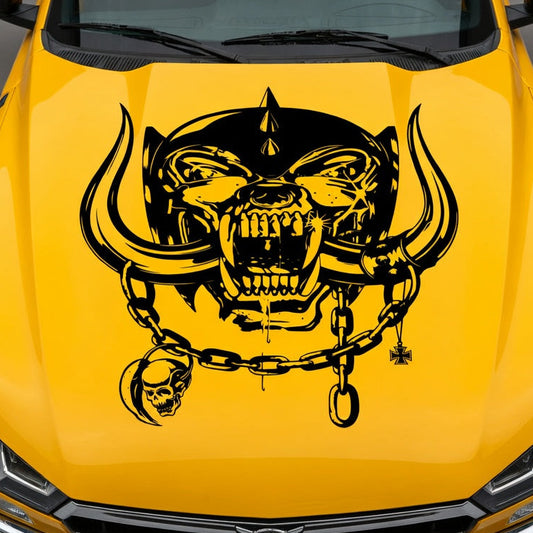 Yellow muscle car with aggressive war pig skull hood decal featuring tusks and chain design