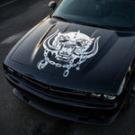 black muscle car with aggressive war pig skull hood decal featuring tusks and chain design