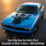 Blue vehicle with a large purple gothic fairy butterfly vinyl decal applied to the hood, featuring a bold fantasy design.