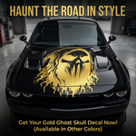 Gold ghost skull with flowing flame design vinyl decal displayed on an black car hood