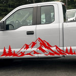 Red mountain range and pine tree side decal on a silver Ford F-150 pickup truck