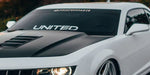 “Custom windshield banner decal with YOUR TEXT in white vinyl, approx. 55×6 in, die‑cut with no background on tinted glass”