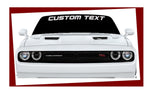 “Custom windshield banner decal with YOUR TEXT in white vinyl, approx. 55×6 in, die‑cut with no background on tinted glass”