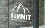 Company logo and website die‑cut white vinyl window decal on shopfront glass, clean professional finish