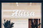 Company logo and website die‑cut white vinyl window decal on shopfront glass, clean professional finish